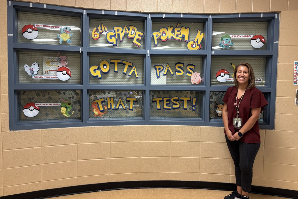 An admin member stands in front of some windows that are decorated for TCAP.