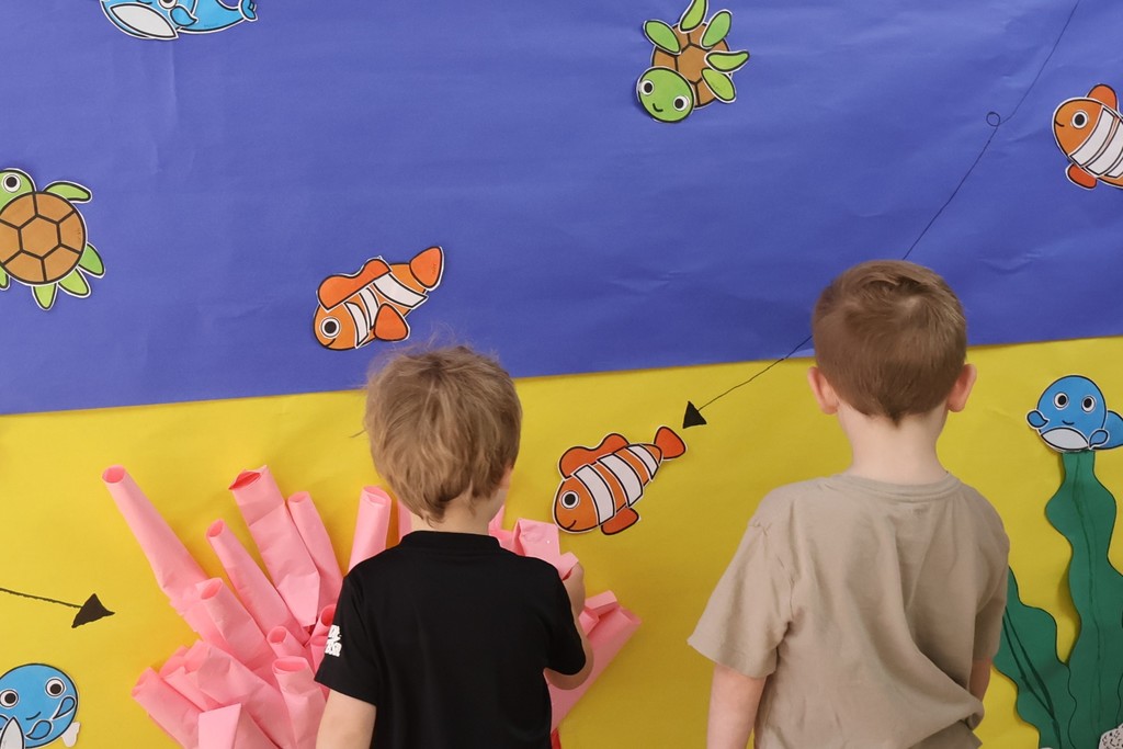 Students  are looking at the interactive coral reef exhibit at Eakin Elementary school. 