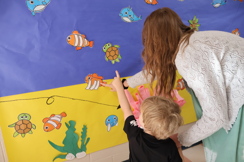 Students and their teachers are looking at the interactive coral reef exhibit at Eakin Elementary school. 