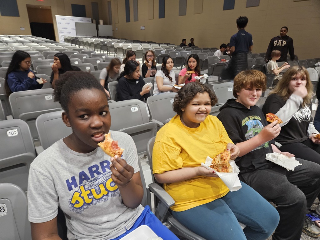Students enjoying a pizza party as a reward