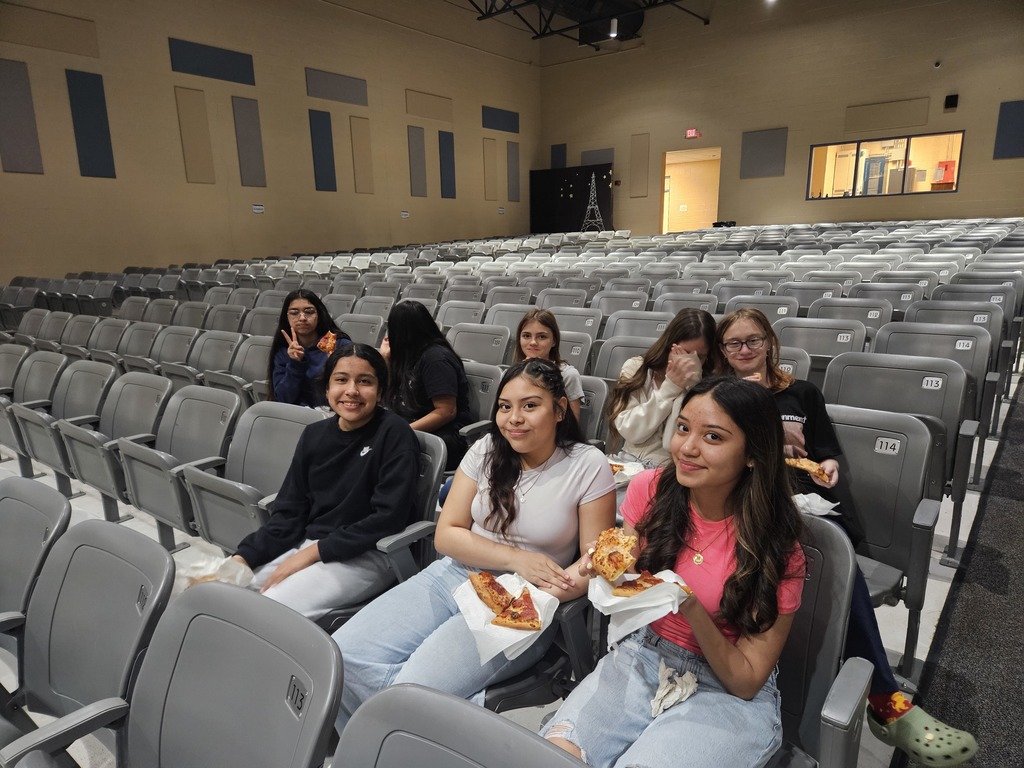 Students enjoying a pizza party as a reward