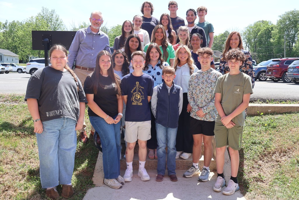 The Superintendent and Assistant Superintendent are posed on the stairs outside the Central Office for a group picture. 