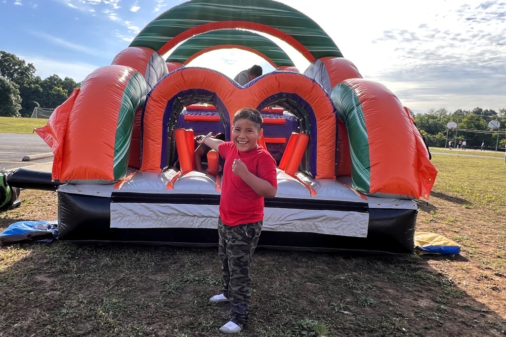 Student stops for a picture in front of a large inflatable. 