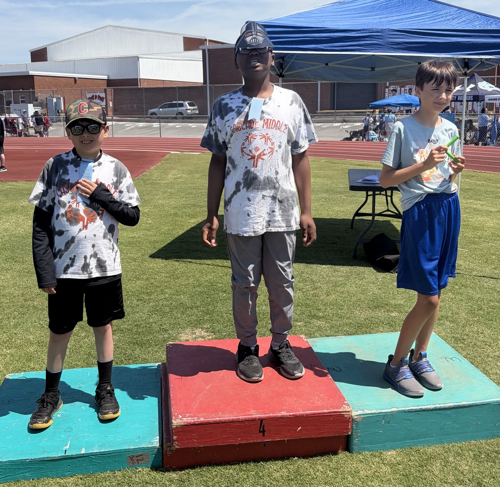 Students receive a ribbon at the Special Olympics.