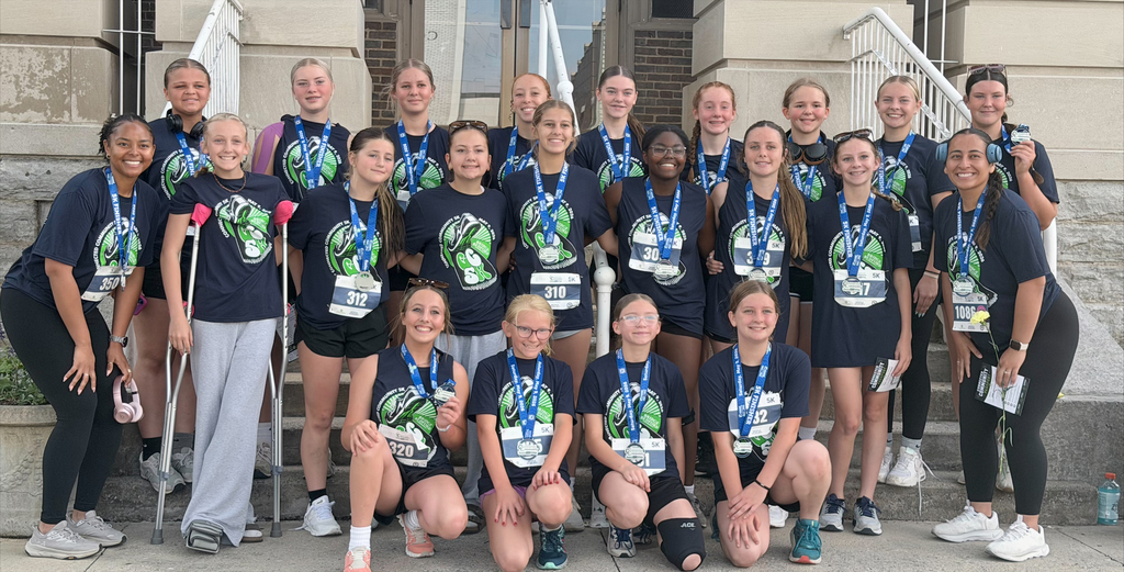 girls smiling with medals