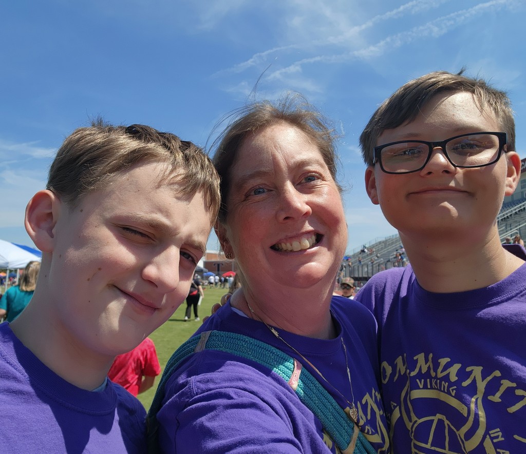 A teacher and two students pose for a picture