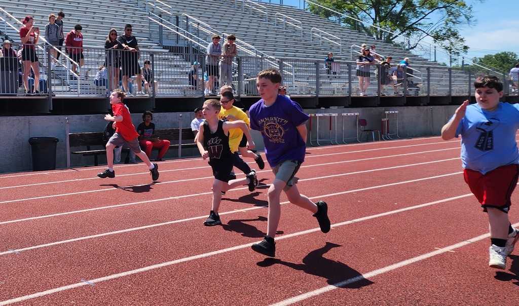 Several students are racing on the track