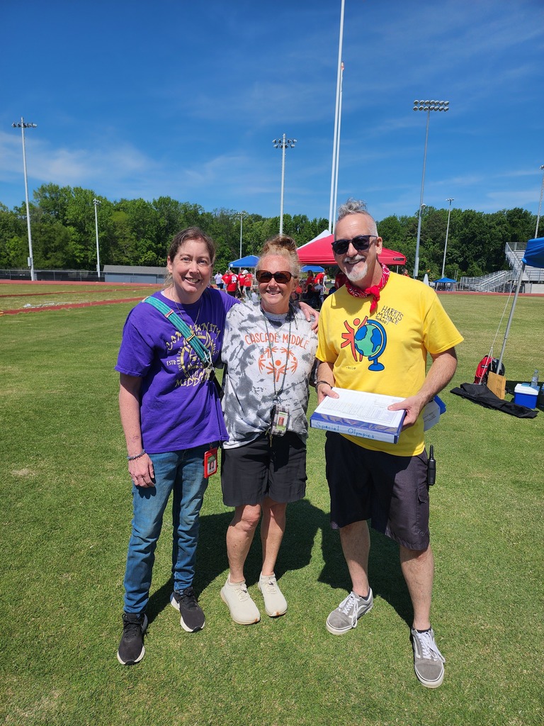 Three teachers pose for a picture at the Special Olympics Competition 