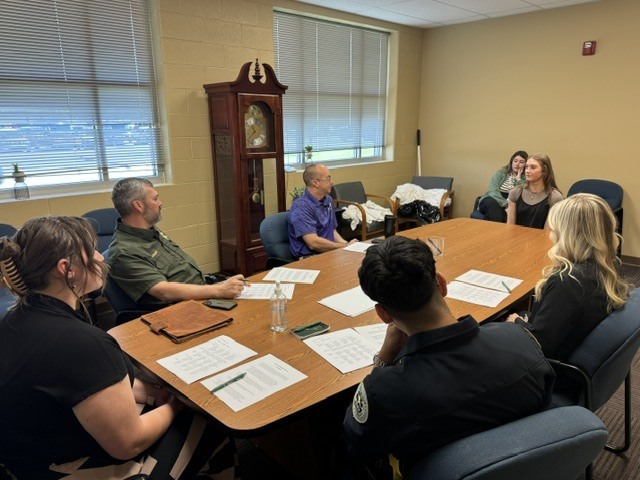 Student is having an interview with several different people from differen professions.