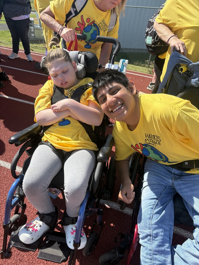 Two student are posing for a picture.