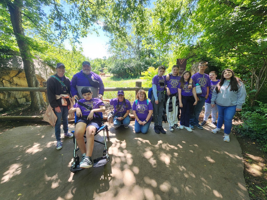Community Middle School students visit the Nashville Zoo and are posing for a group picture. 