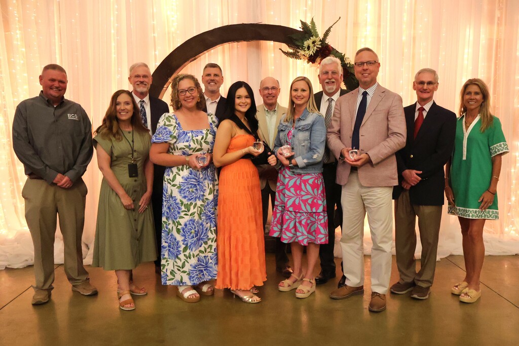 A group photo of those who received award along with the school board members, superintendent and assistant superintendent. 