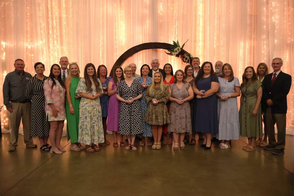 A group photo of those who received award along with the school board members, superintendent and assistant superintendent. 