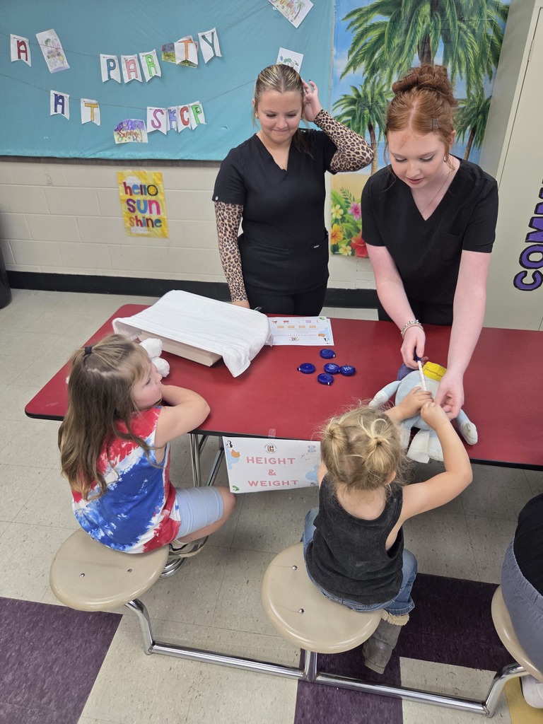 Medical Therapeutic students participate in the stuffie clinic with two students and their stuffed animals. 