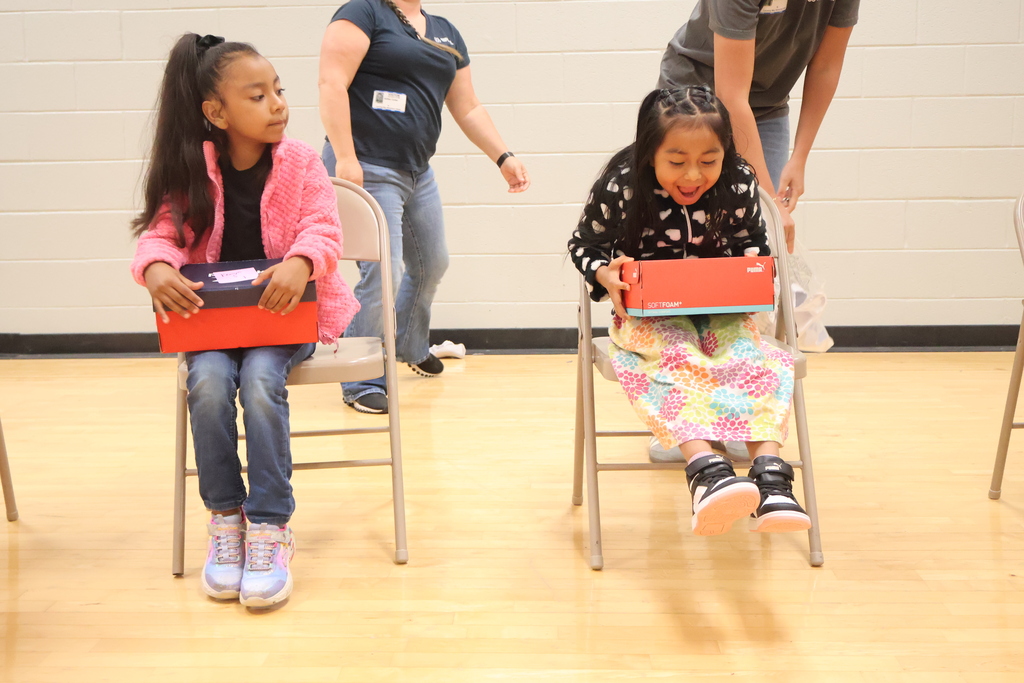 A student is excited over the new shoes she just received. 