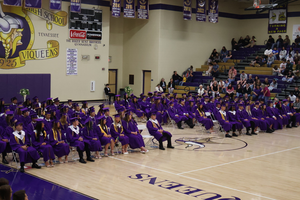 A whole group picture of students seated on the gym floor during honor's day.