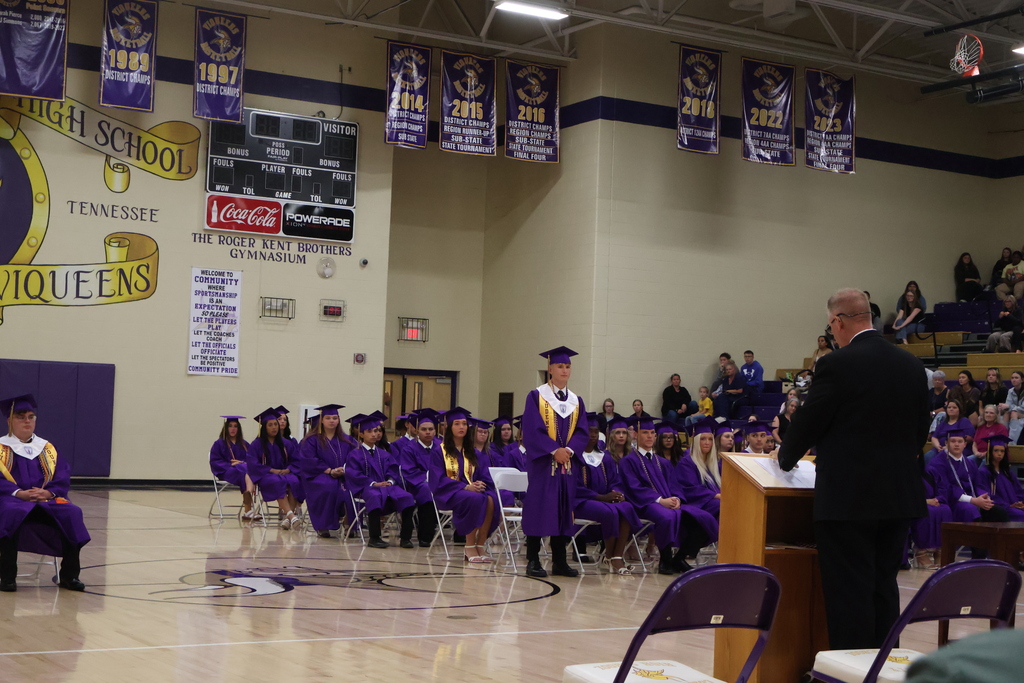 A student is standing up while be recognized for an award. 