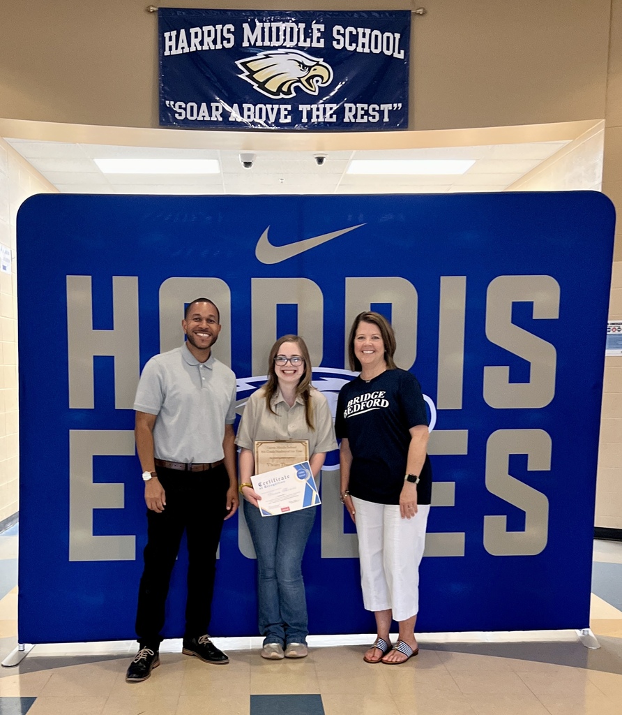 The HERO award recipient from Harris Middle School poses for a picture with two other people. 