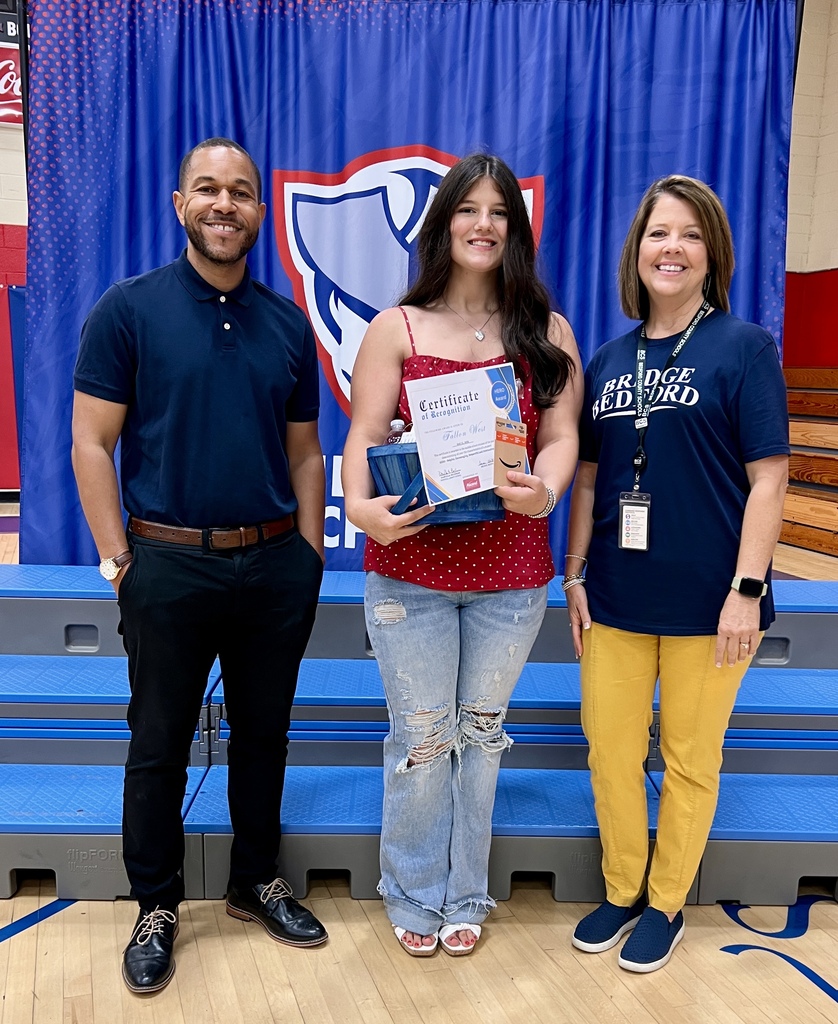 The HERO award recipient from Liberty School poses for a picture with two other people. 