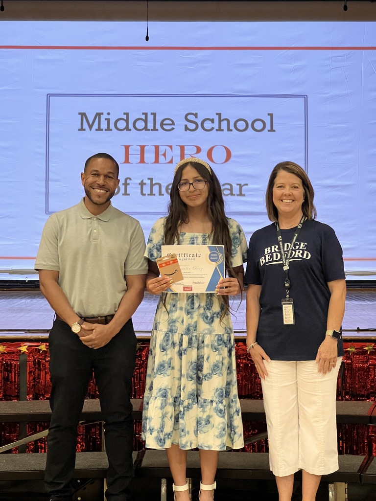 The HERO award recipient from Thomas Magnet School poses for a picture with two other people. 