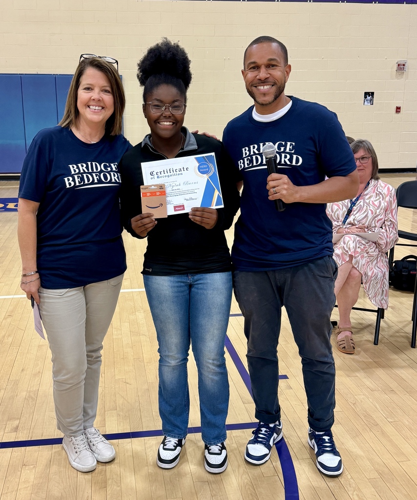The HERO award recipient from Community Middle School poses for a picture with two other people. 