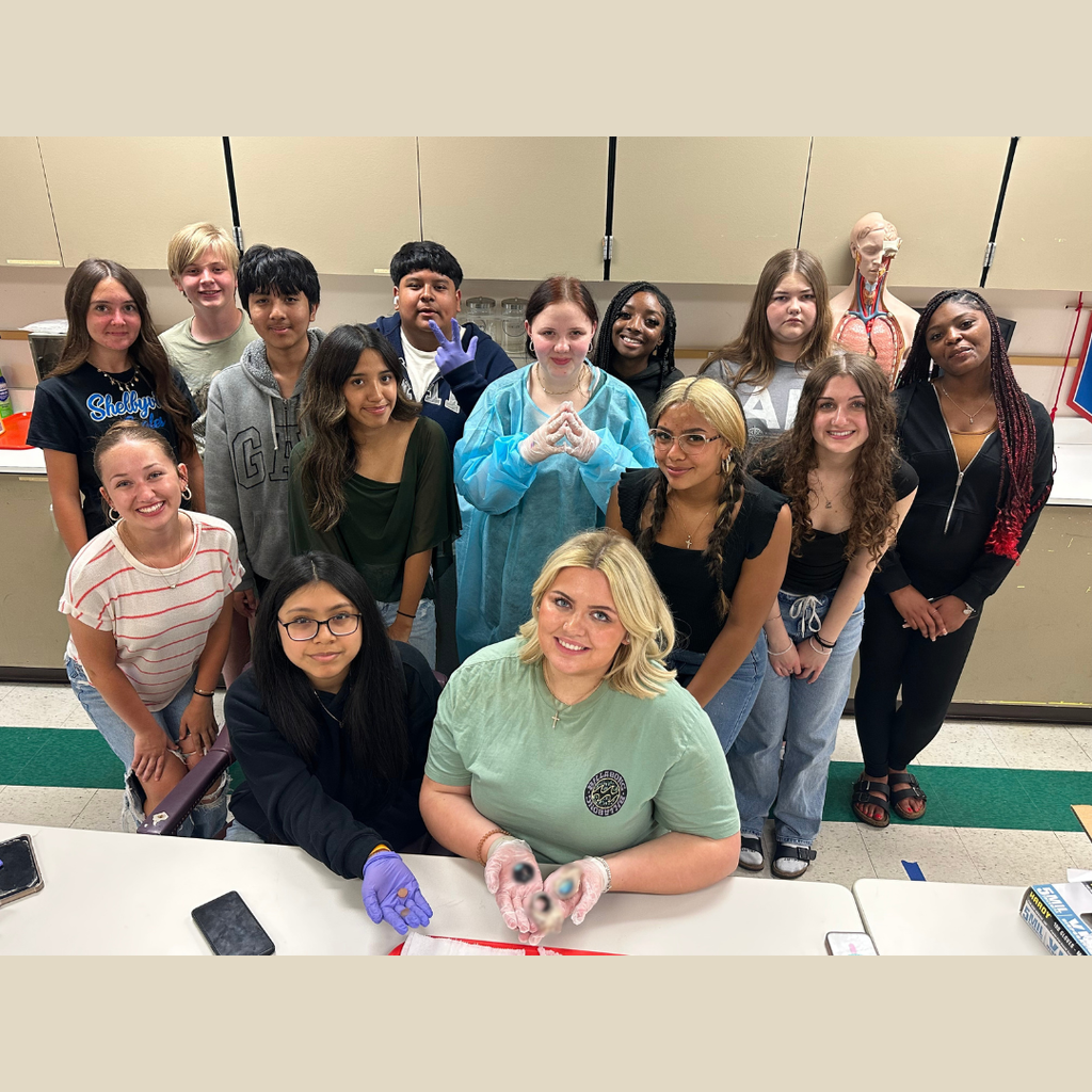 Students are posed for a group picture for their vision dissection unit. 