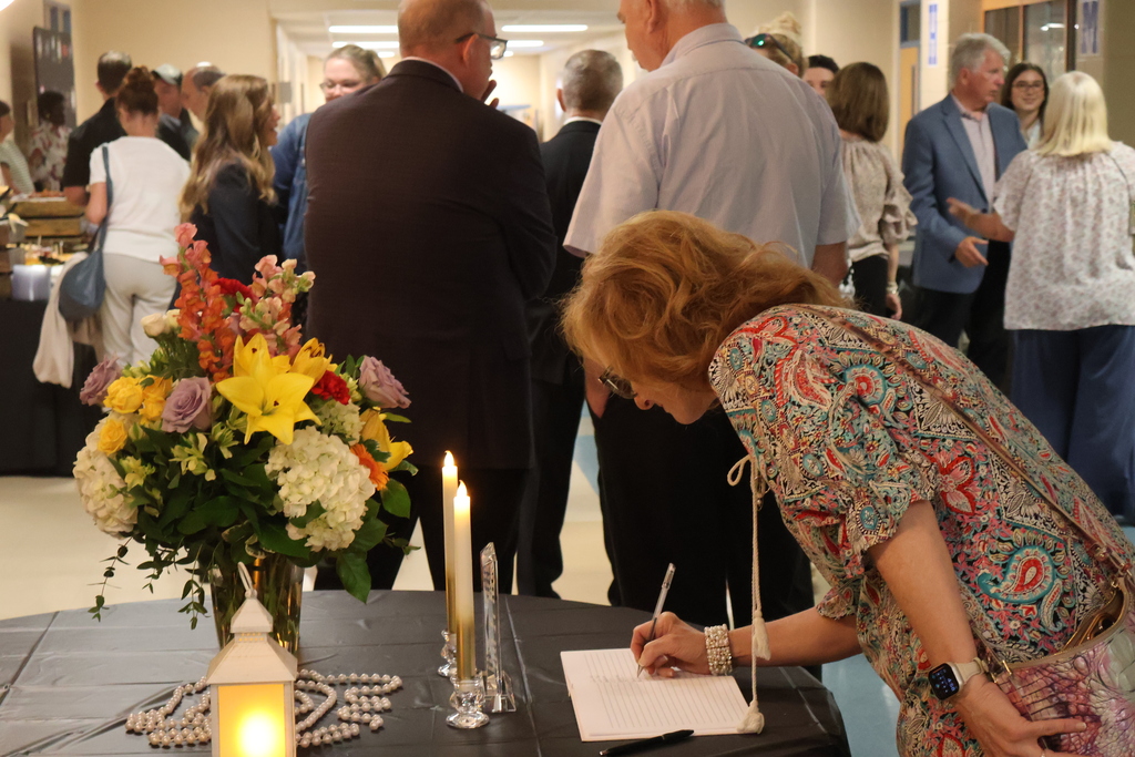 People are signing the guest book at Dr. Garrett's Board Retirement Reception.