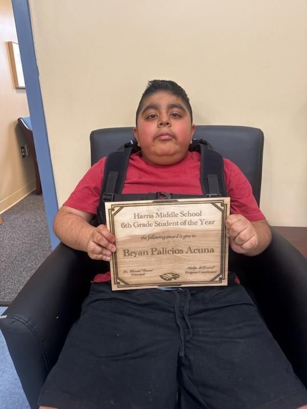 Bryan chiiling in the office with his award