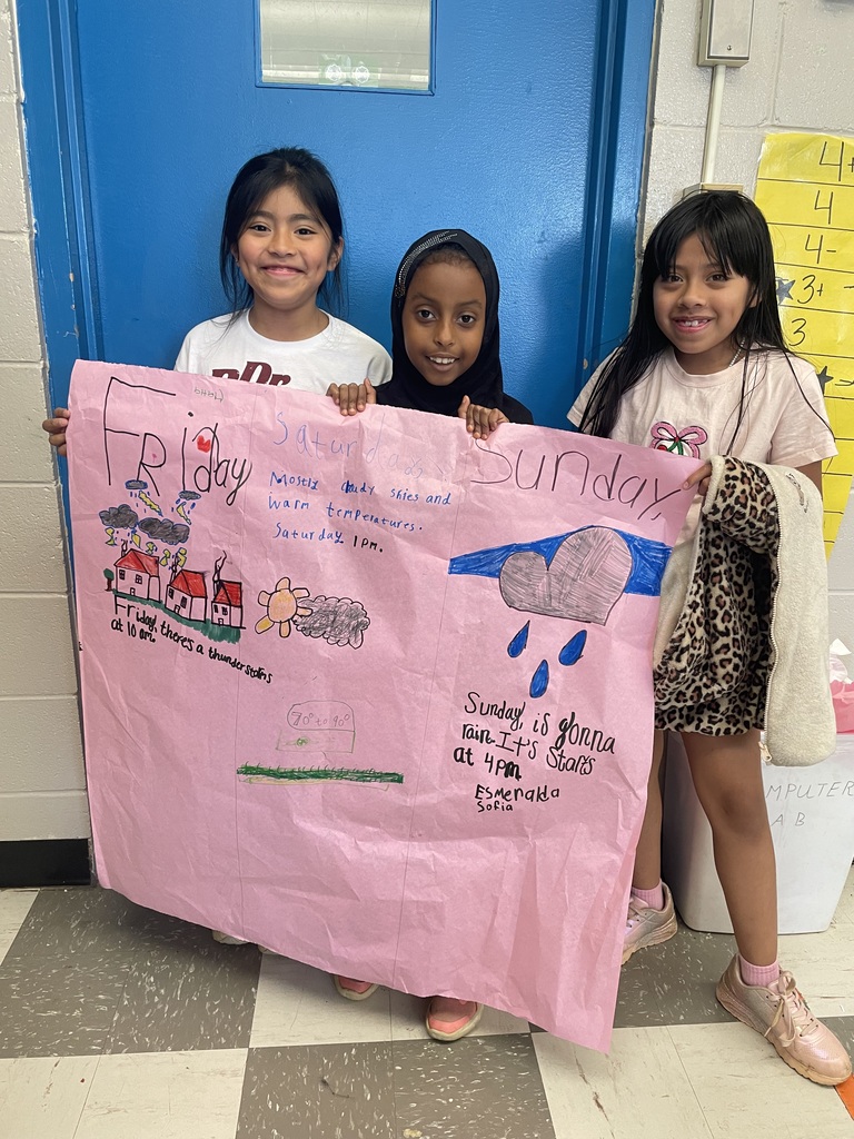 There are three students holding up a large piece of pink paper that they used to make their predictions for this weekend's weather forecast.