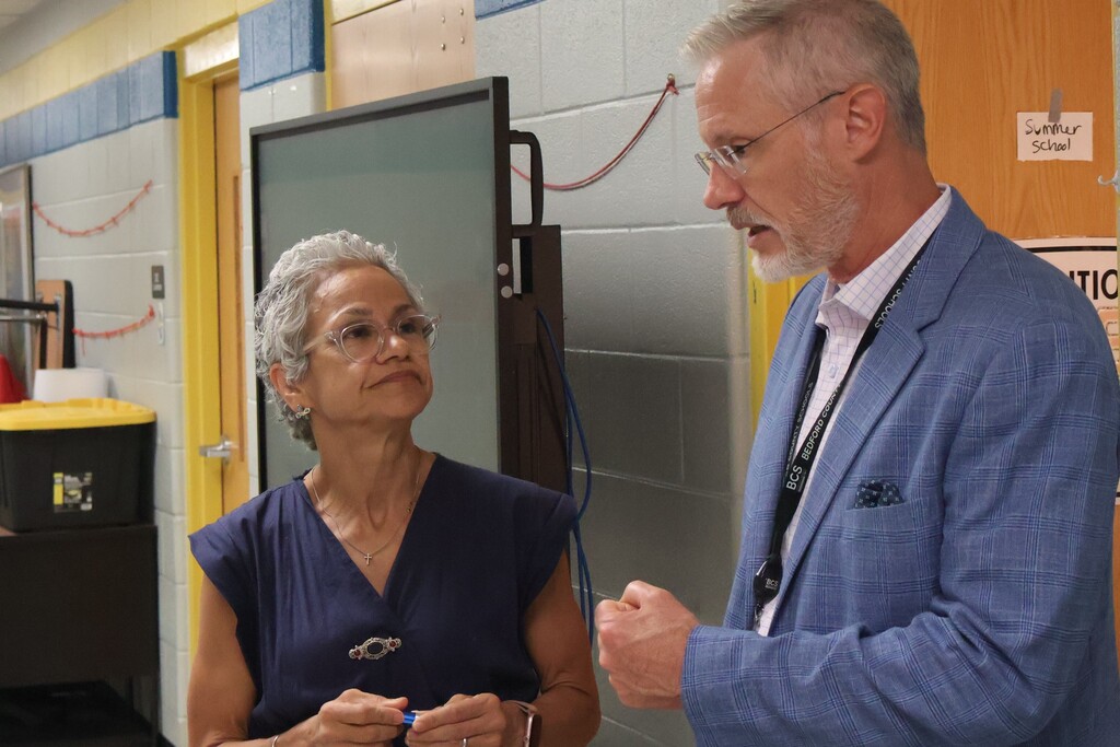 Superintendent Tim Harwell and Tennessee Commissioner of Education, Lizzette Reynolds, are in the hallway talking. 
