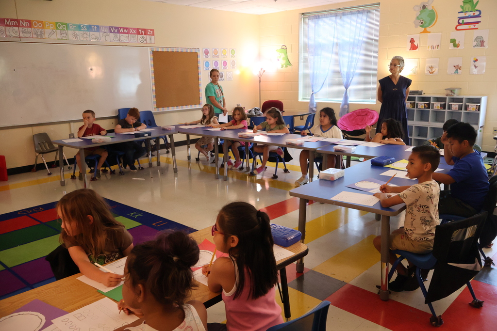 Students are seated at their desks as the teacher and other members from Tennessee Commissioner of Education, Lizzette Reynolds', team looks on.