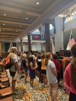 Students are standing inside of a room learning more about Tennessee's history.