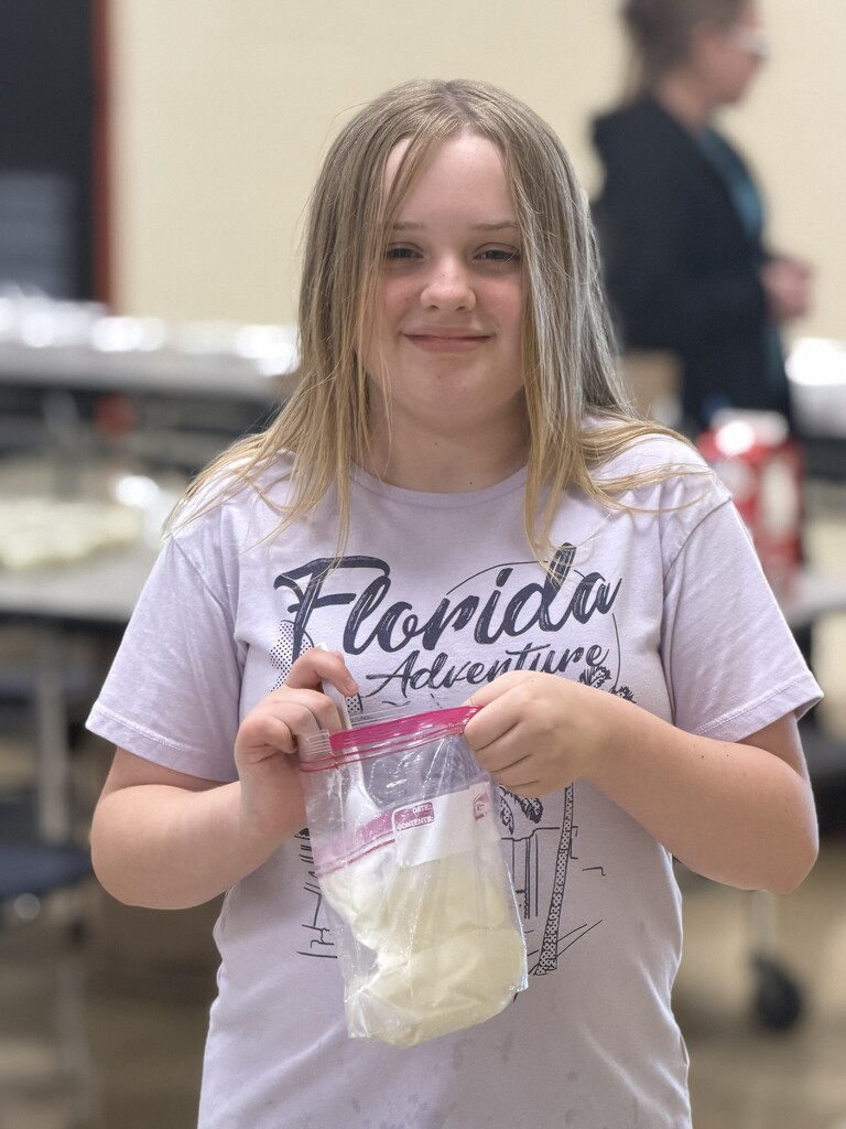 A student is trying out the ice cream that they just made in a bag.