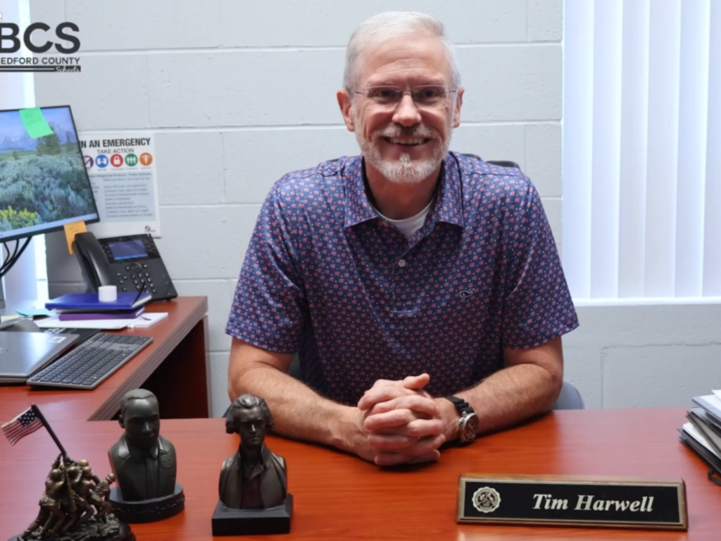 Superintendent Tim Harwell is sitting at his desk.