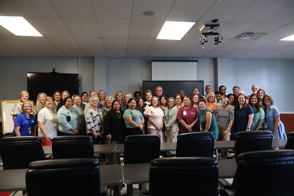 The Central Office staff members are all standing in the staff development room for a group picture. 