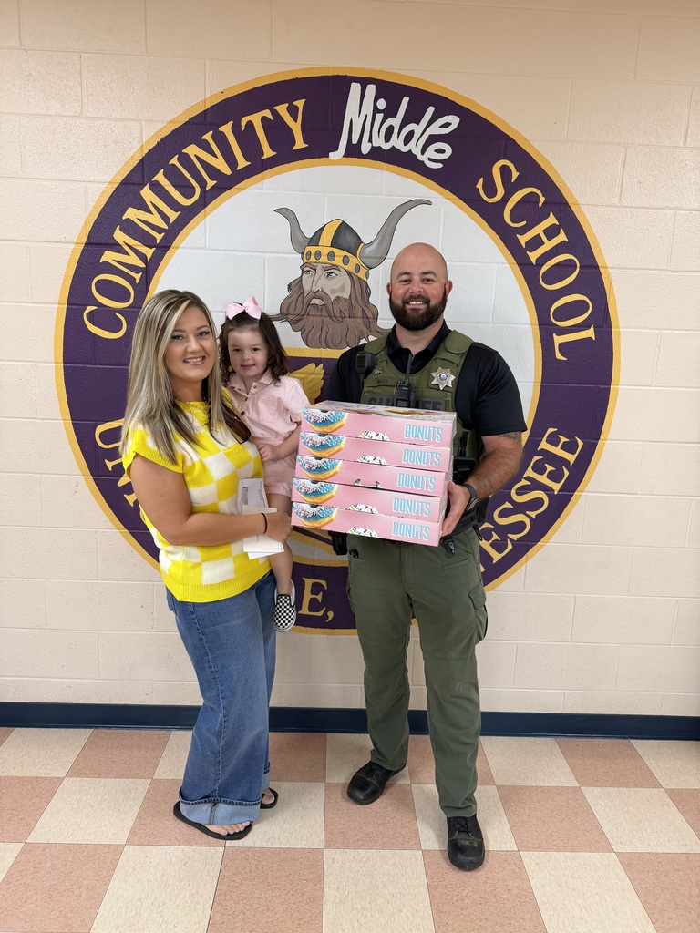 people smiling with donuts