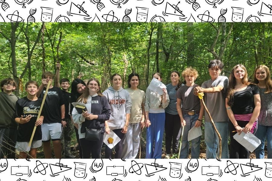 Group of approximately 15-16 freshman Physical Science students with tools on forest trail. 