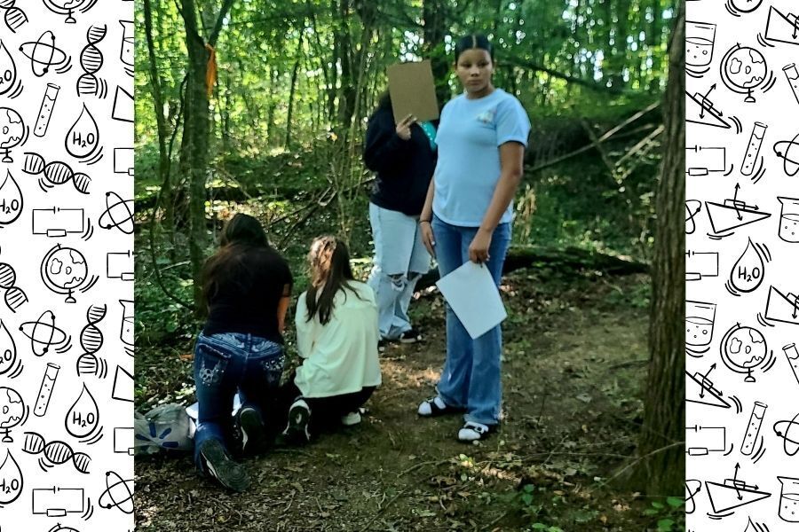 Students gathered on wooded trail during Physical Science outdoor scavenger hunt activity