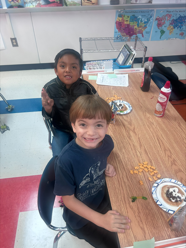 2 boys smiling and eating pancakes
