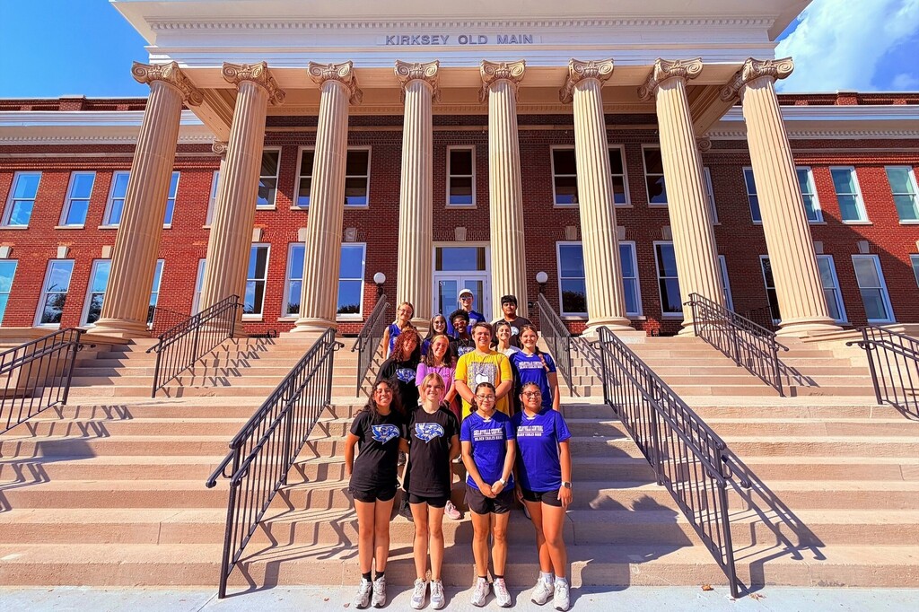 The band members from SCHS are posed for a picture outside on the stairs of the Kirksey Old Main building.