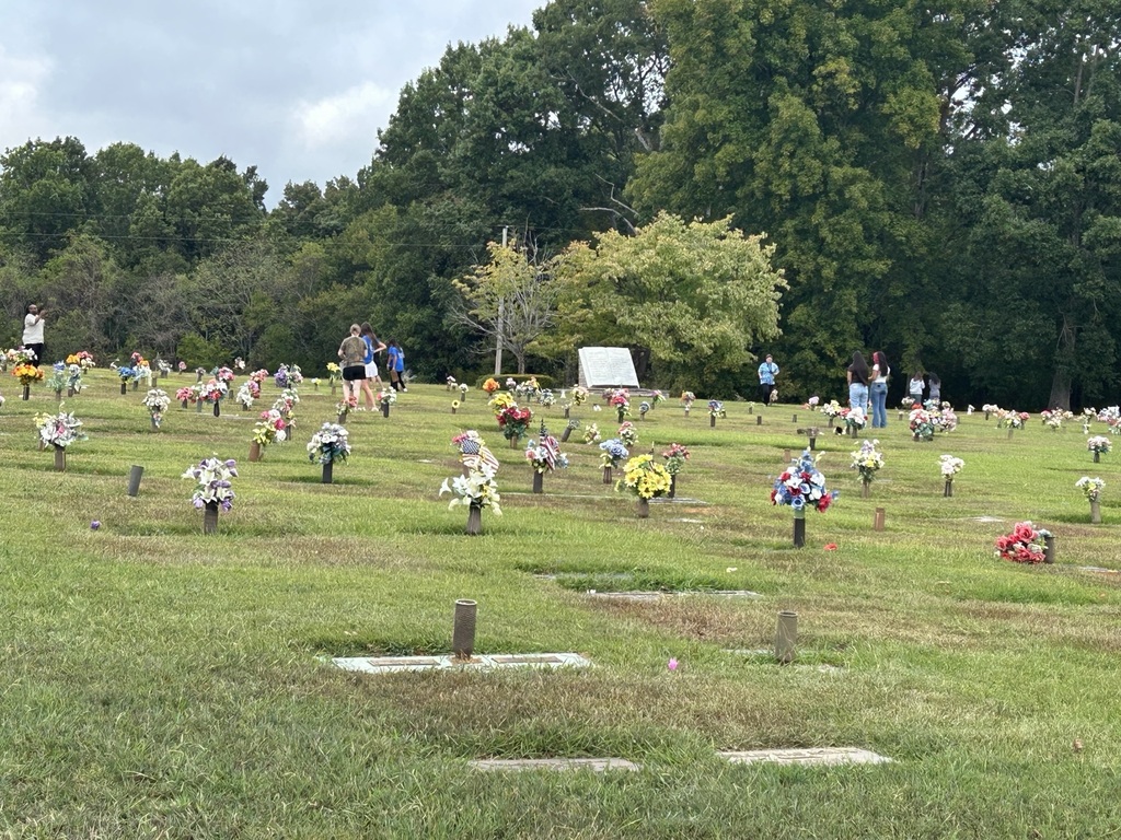 This is a zoomed out picture of the students that are walking through the cemetery and gathering information. 