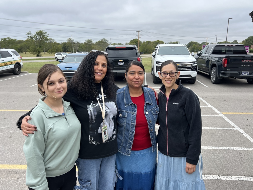 A group of women all pose for a picture. 