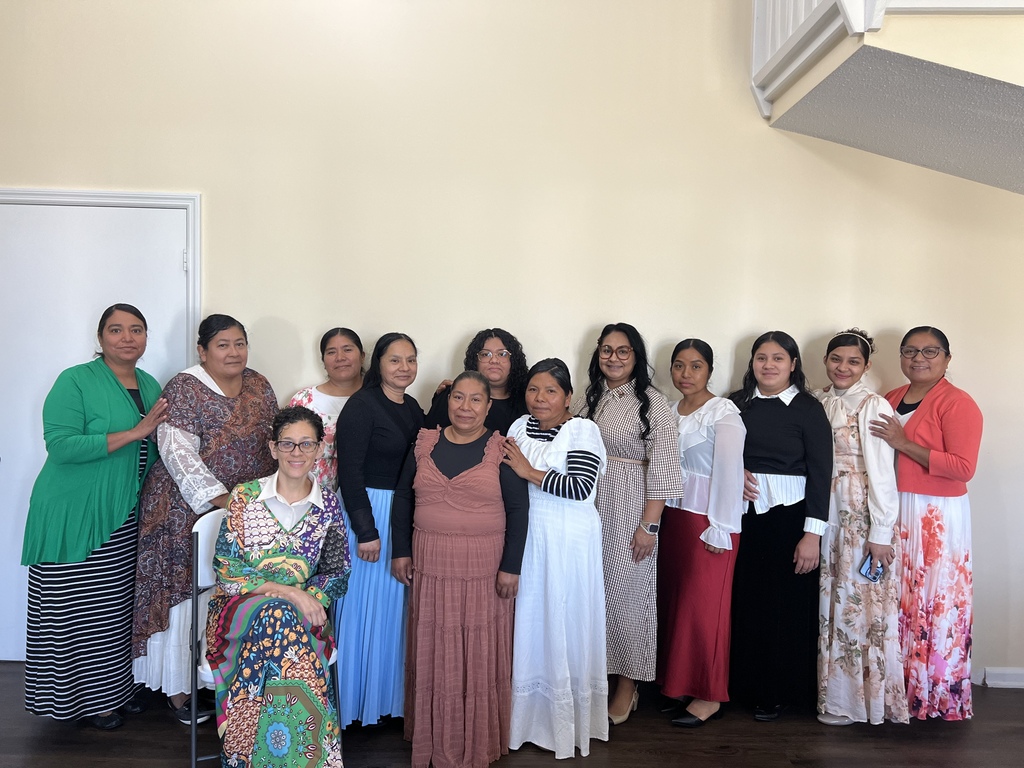 A group of women all pose for a picture. 