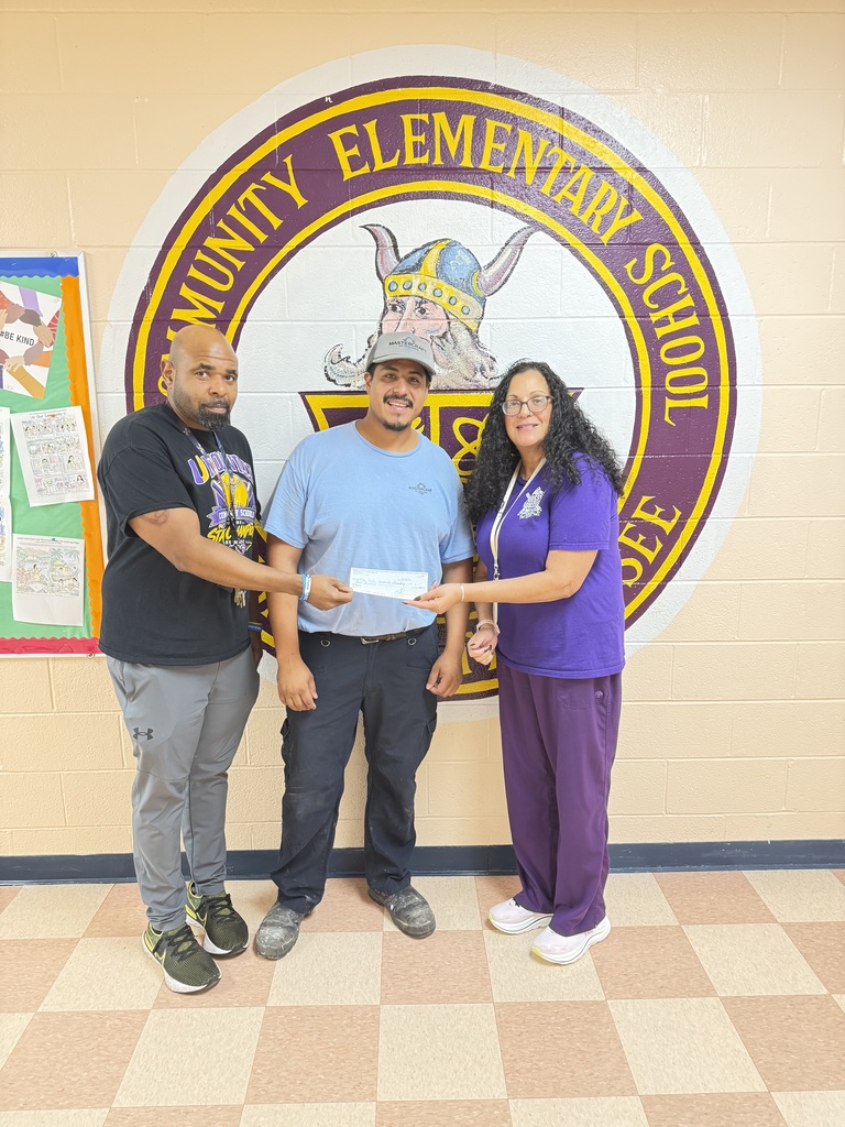 A woman and two men pose for a picture while they are holding a check that was donated. 