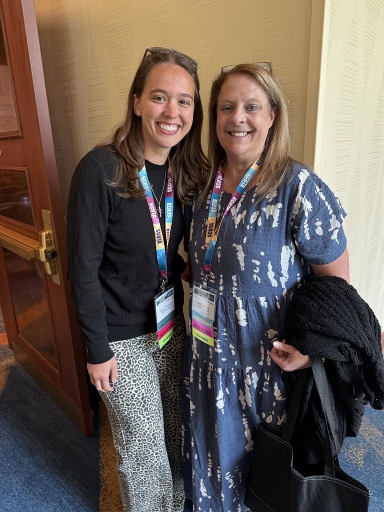 Two women are posed for a picture at the SCALI conference. 