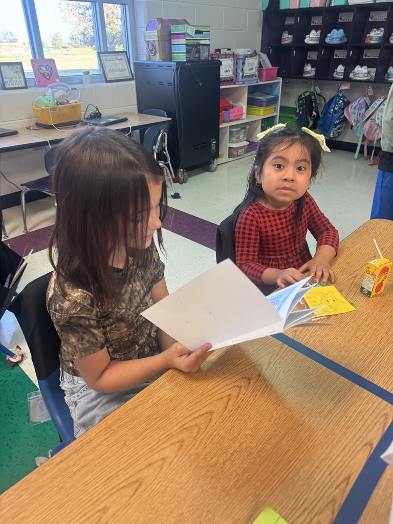 1 student reading to another