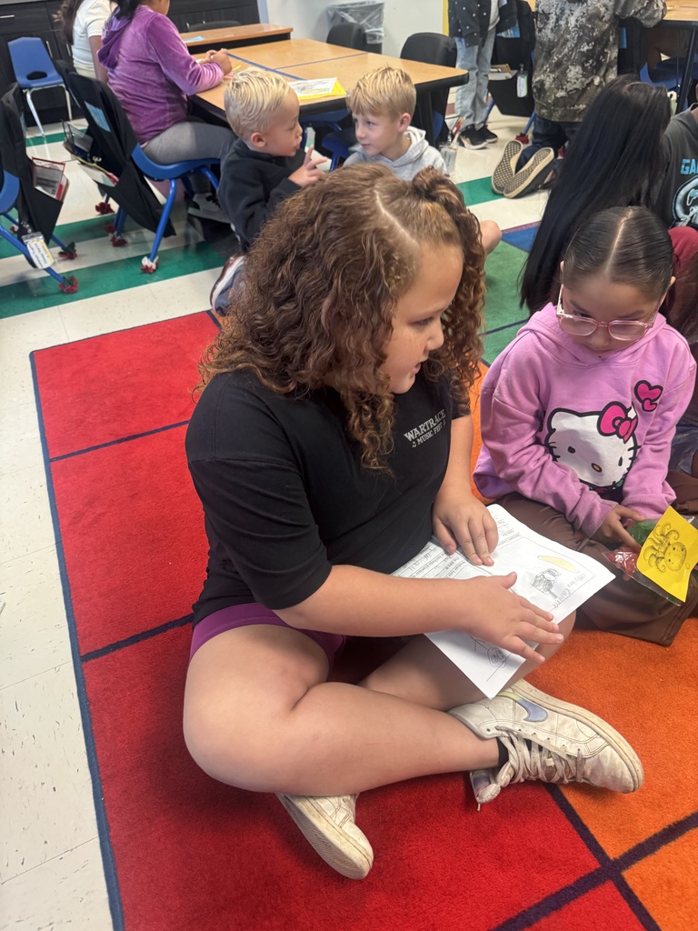 1 student reading to another