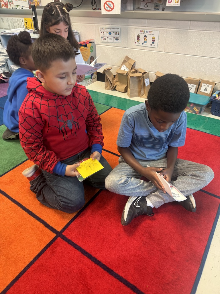 1 student reading to another
