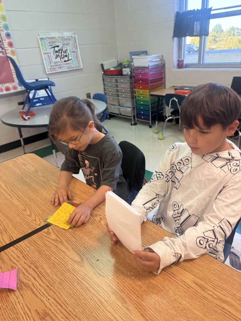 1 student reading to another