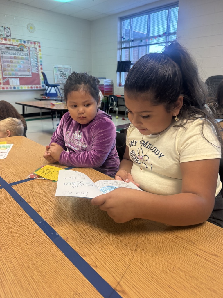 1 student reading to another
